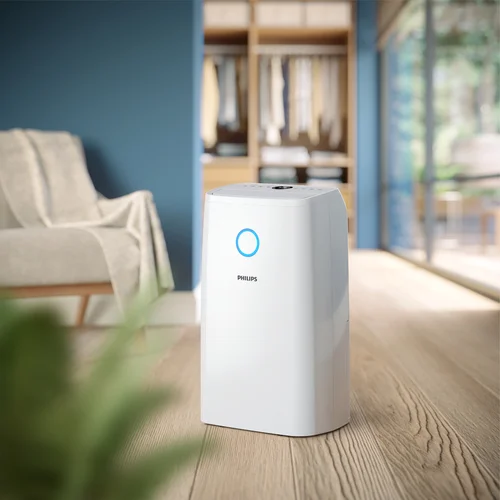 Philips DE3306 Sahara+ posé dans une buanderie à côté d'un étendoir à linge